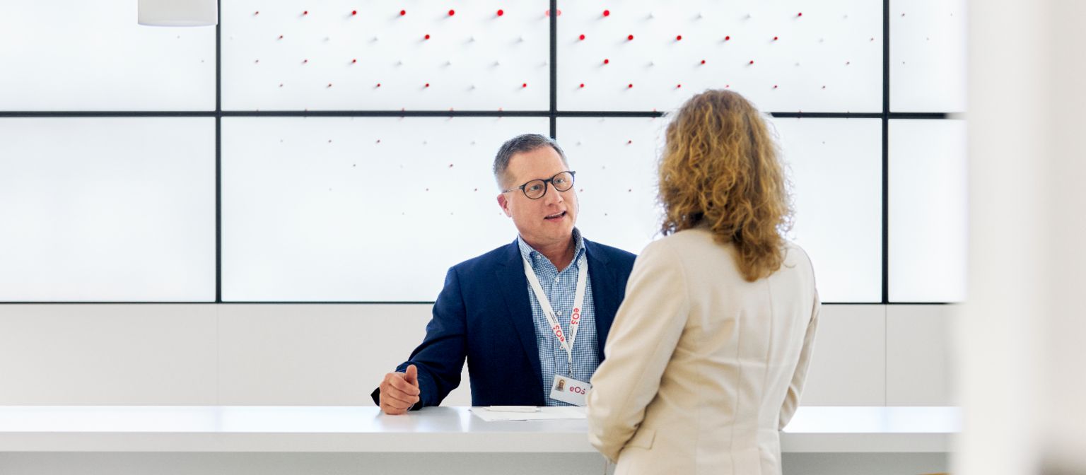 EOS employee talking with client in EOS lobby