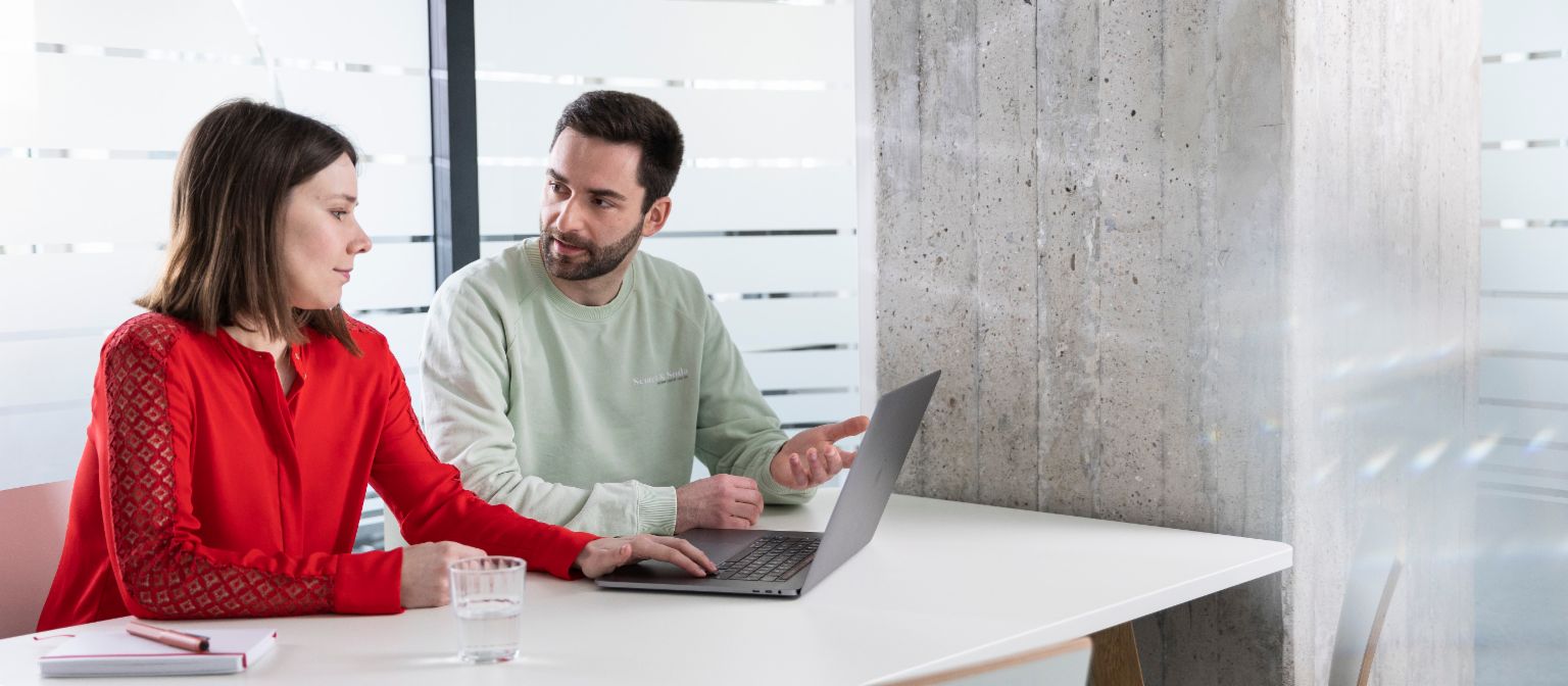 Two EOS colleagues with laptop in meeting room
