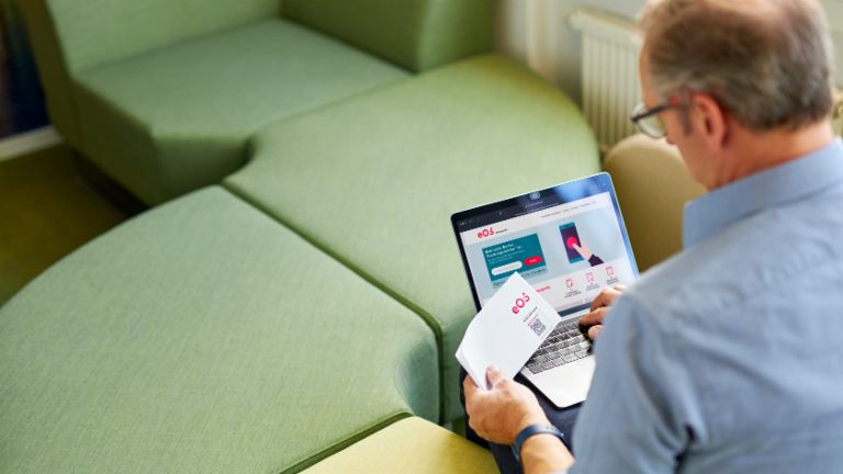 Man who makes a payment via qr code and laptop