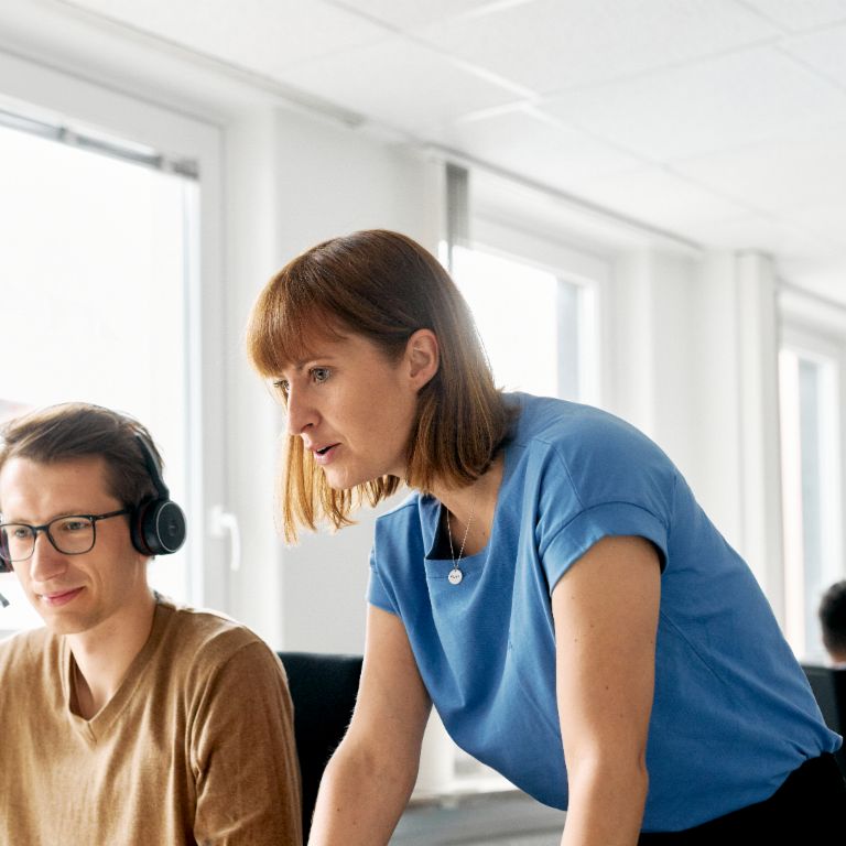 EOS employee explains something to a colleague