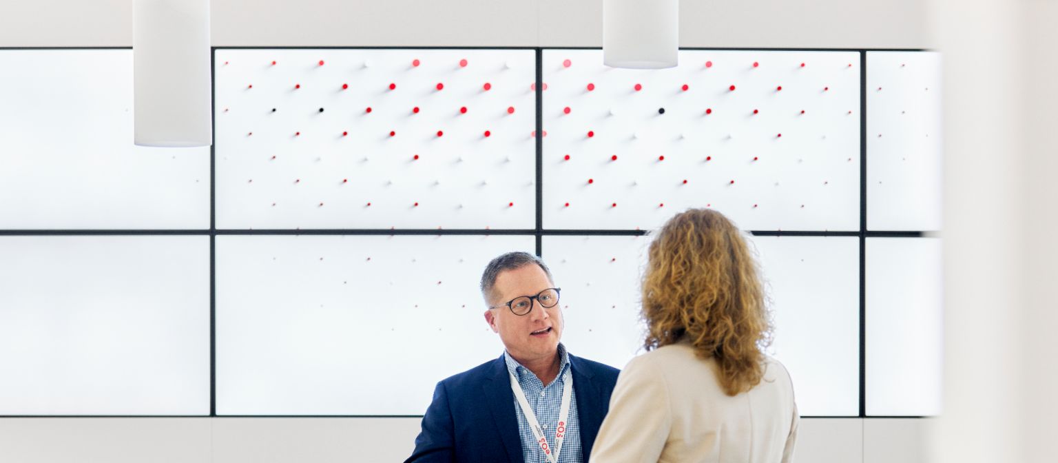 EOS employee talking with client in EOS lobby