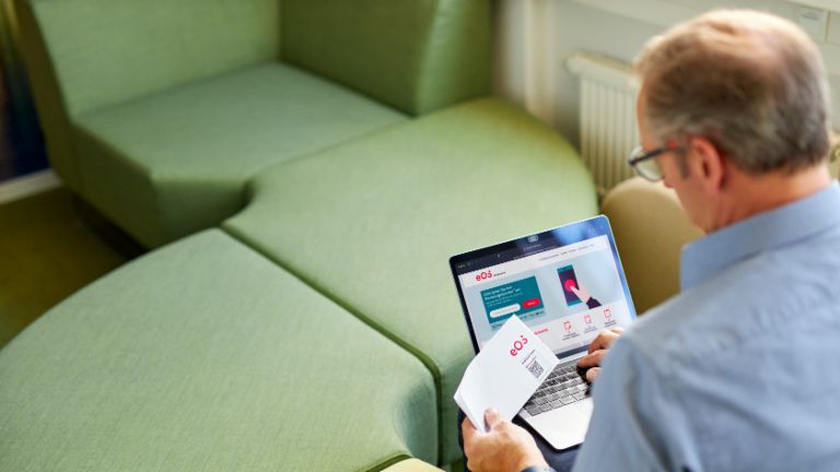 Man who makes a payment via qr code and laptop
